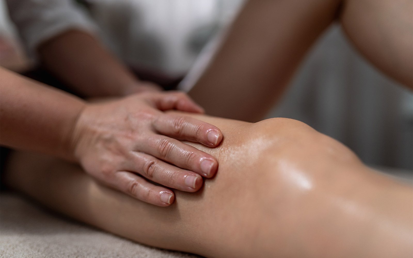 Woman making a knee massage after surgery