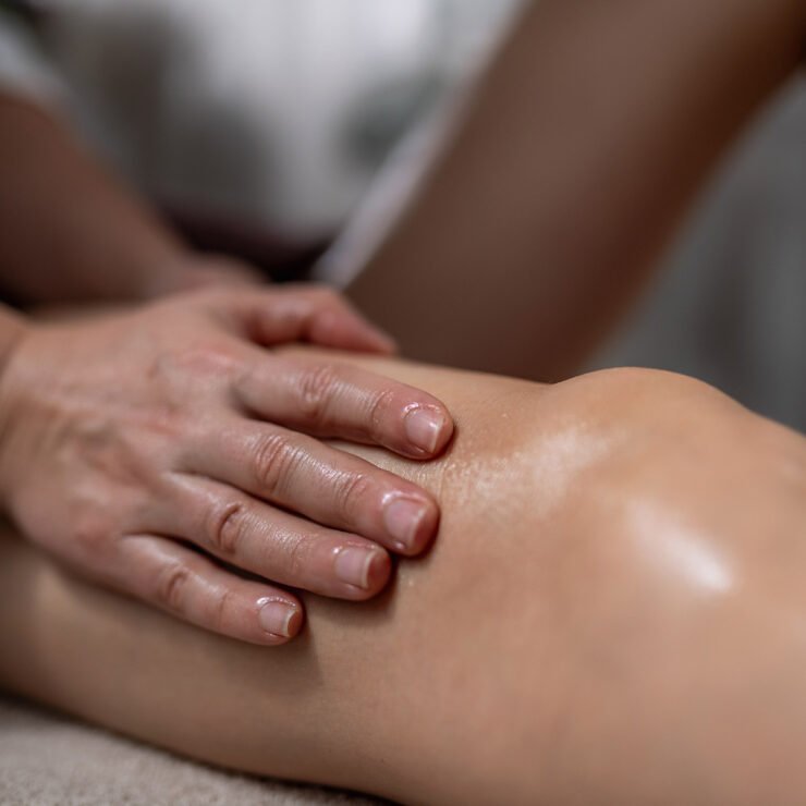 Woman making a knee massage after surgery