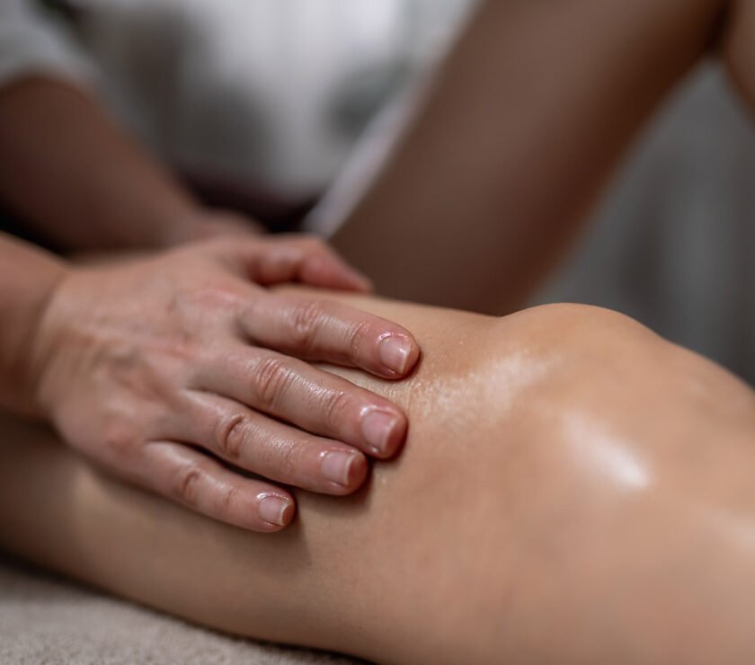 Woman making a knee massage after surgery